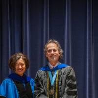 Provost Mili smiles on stage